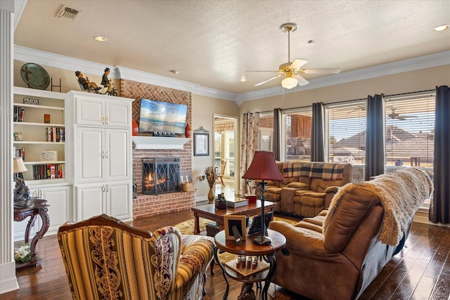 living room with crown molding, a fireplace, dark hardwood / wood-style flooring, and a textured ceiling