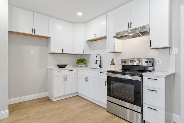 kitchen featuring stainless steel electric stove and white cabinets