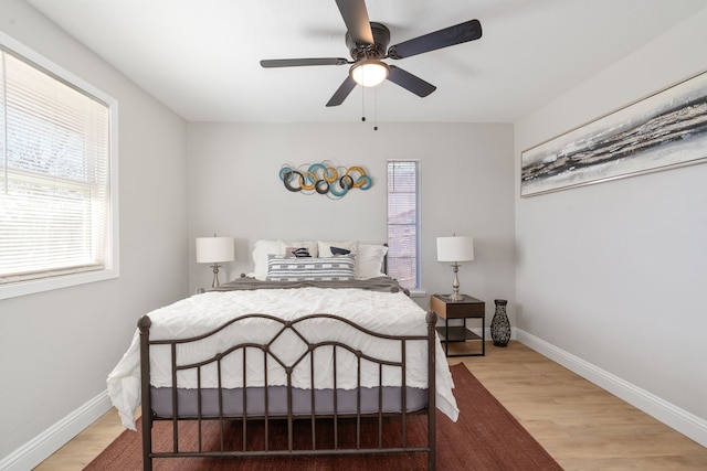 bedroom with ceiling fan and light hardwood / wood-style flooring