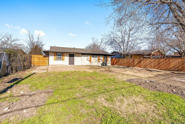 rear view of house featuring a yard