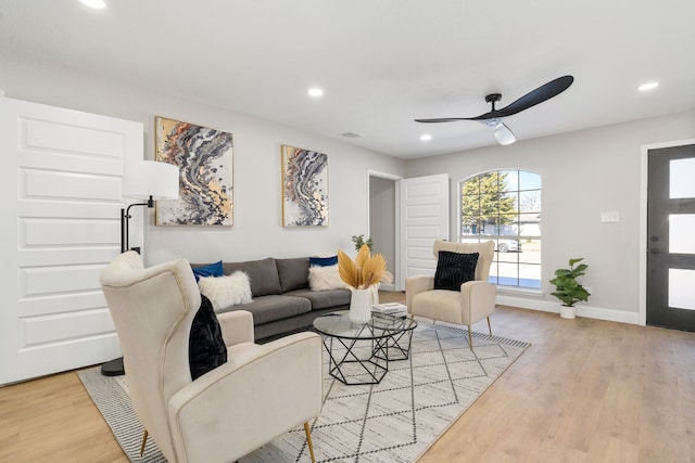 living room featuring ceiling fan and light wood-type flooring