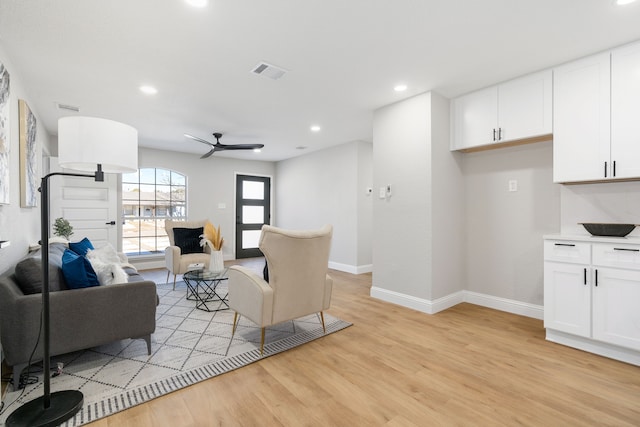 living room featuring ceiling fan and light wood-type flooring