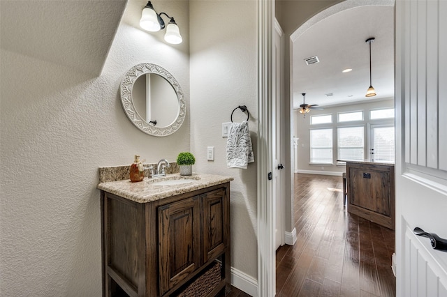 bathroom with vanity, ceiling fan, and wood-type flooring