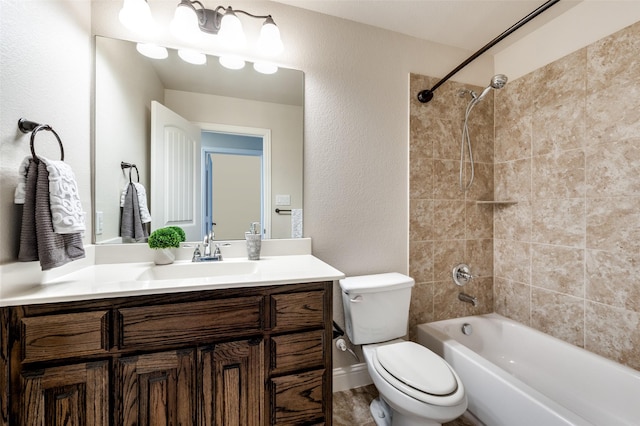 full bathroom featuring toilet, tiled shower / bath, and vanity