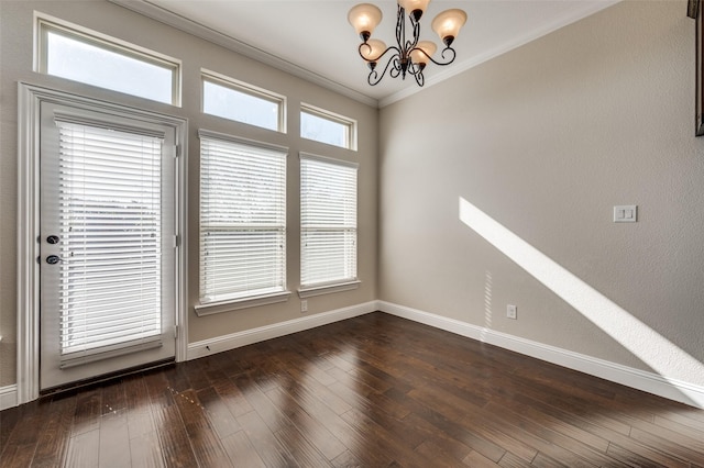 spare room featuring plenty of natural light, dark hardwood / wood-style flooring, and ornamental molding