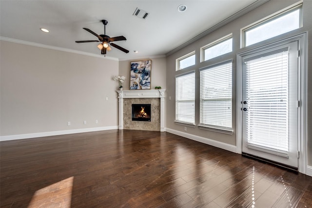 unfurnished living room with ceiling fan, dark wood-type flooring, and crown molding