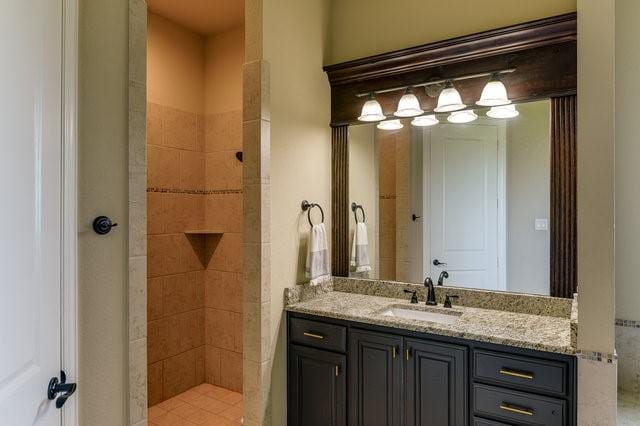 bathroom featuring walk in shower and vanity