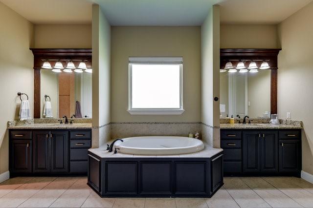 bathroom featuring a bath, tile patterned floors, and vanity