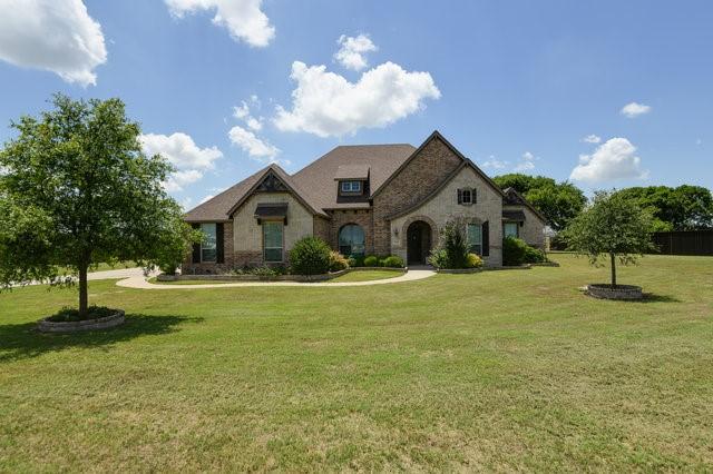 french country style house featuring a front yard