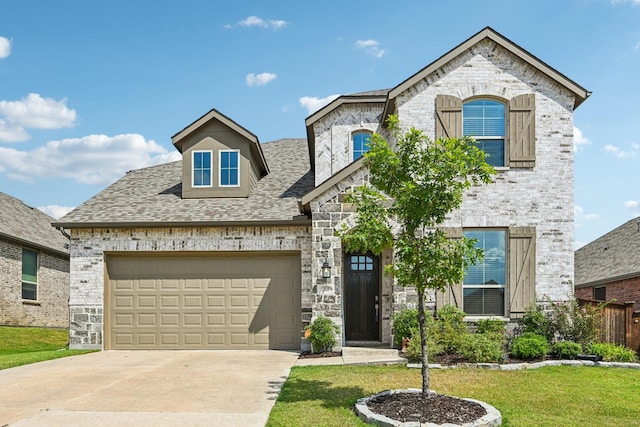 view of front of property with a garage and a front yard