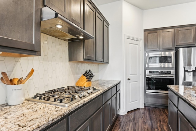 kitchen featuring dark brown cabinets, dark hardwood / wood-style floors, ventilation hood, and stainless steel appliances