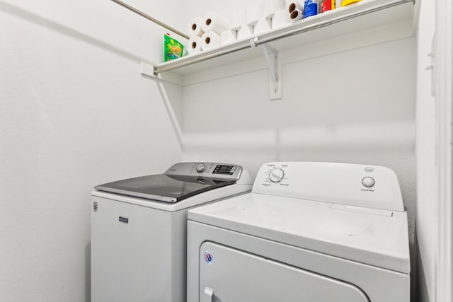 laundry room with washing machine and clothes dryer