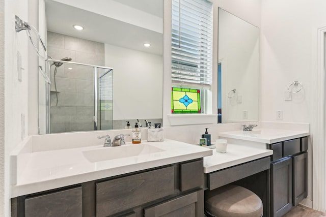 bathroom with vanity and a shower with door