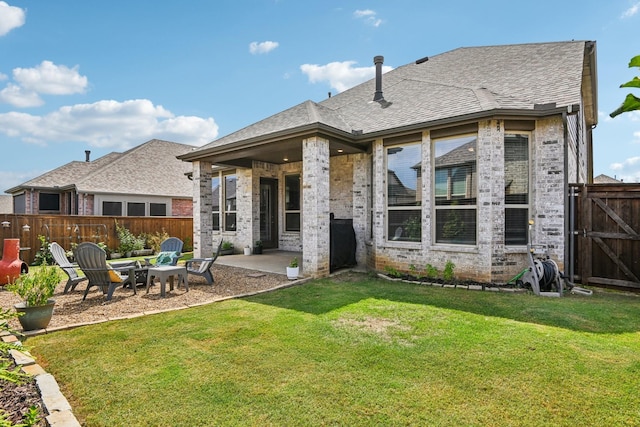 back of house with a patio and a yard