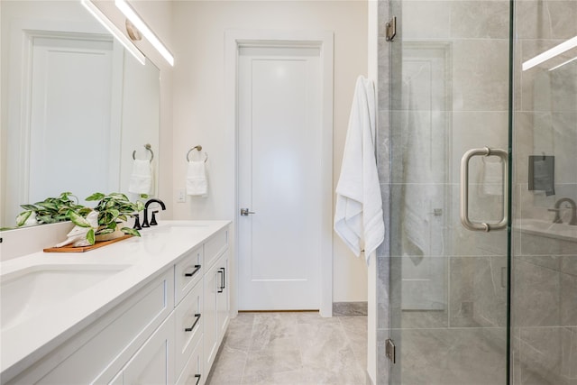 bathroom with walk in shower and vanity