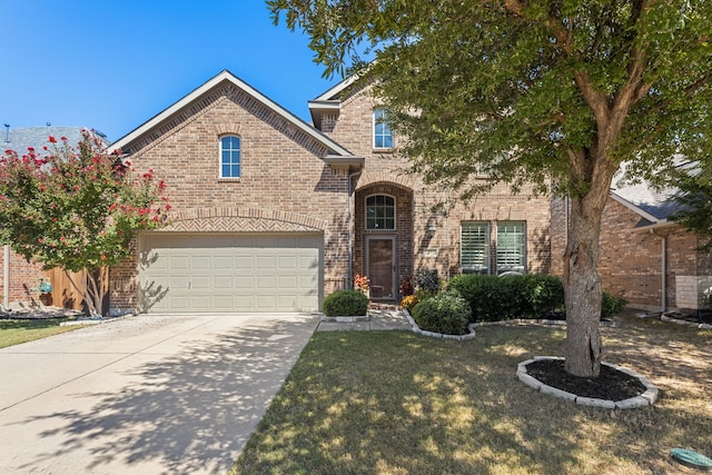 view of front of property with a front yard and a garage