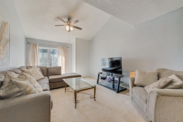 carpeted living room with a textured ceiling, vaulted ceiling, and ceiling fan