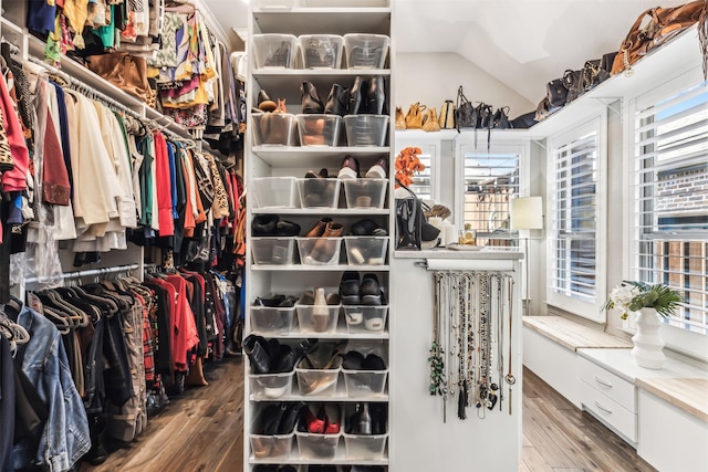 spacious closet with hardwood / wood-style flooring and lofted ceiling