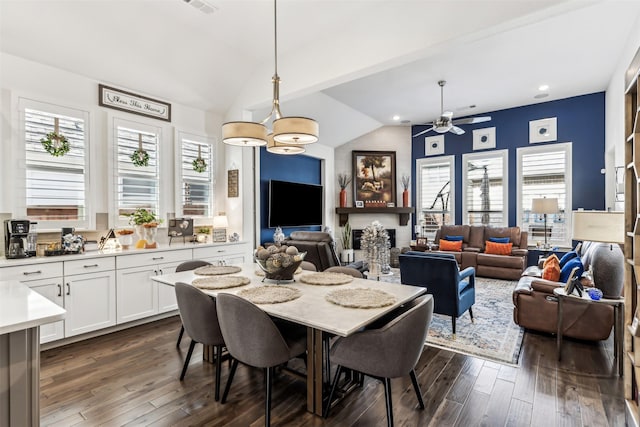 dining area featuring ceiling fan, dark hardwood / wood-style flooring, and lofted ceiling