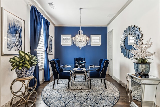 dining area with plenty of natural light, dark hardwood / wood-style flooring, crown molding, and an inviting chandelier