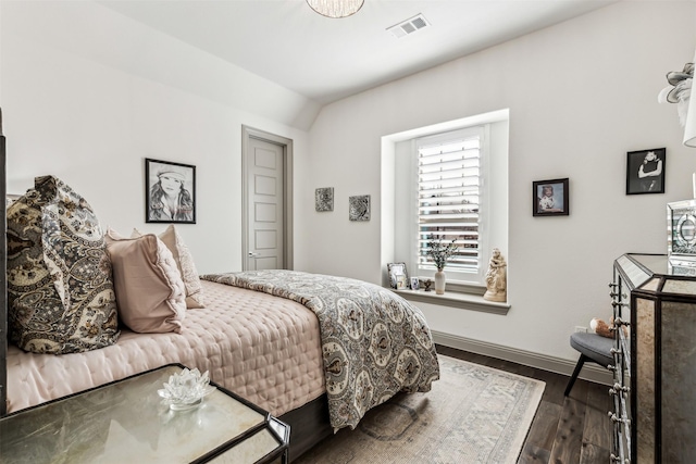 bedroom featuring dark hardwood / wood-style floors and vaulted ceiling