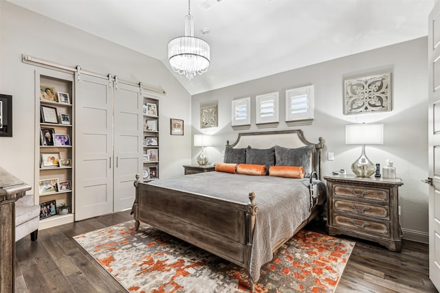 bedroom with a chandelier, dark hardwood / wood-style floors, vaulted ceiling, and a barn door