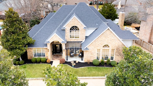 view of front of home with a patio area and a front yard