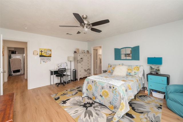 bedroom with ceiling fan and light wood-type flooring