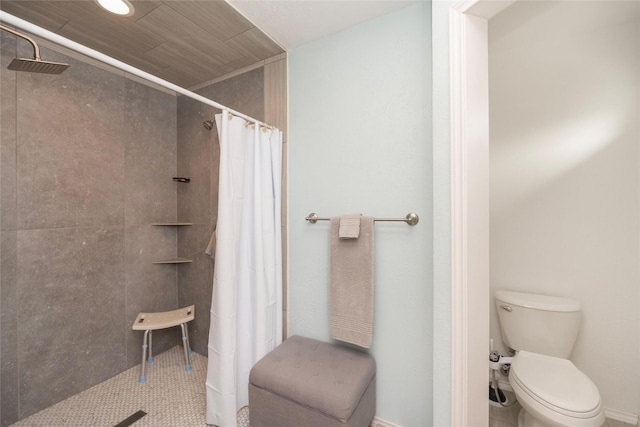 bathroom featuring curtained shower and toilet