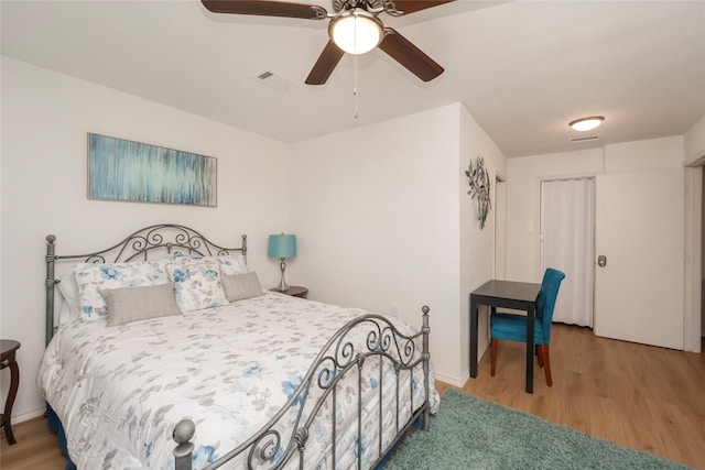 bedroom with ceiling fan and hardwood / wood-style flooring