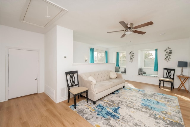 living room featuring light hardwood / wood-style floors and ceiling fan