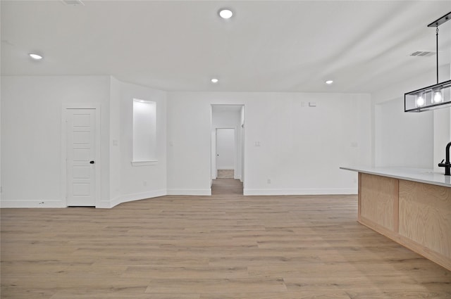 unfurnished living room with light hardwood / wood-style flooring