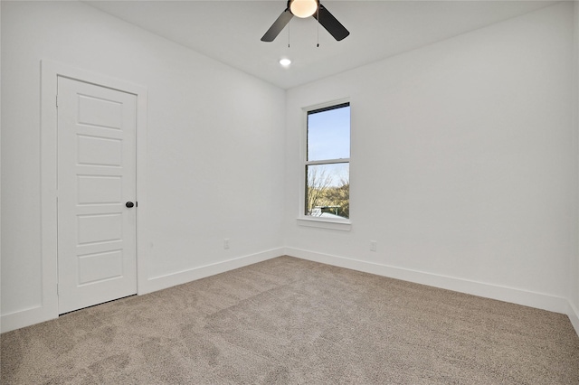 spare room featuring carpet flooring and ceiling fan