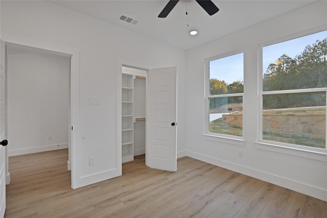 unfurnished bedroom with a closet, ceiling fan, and light hardwood / wood-style floors