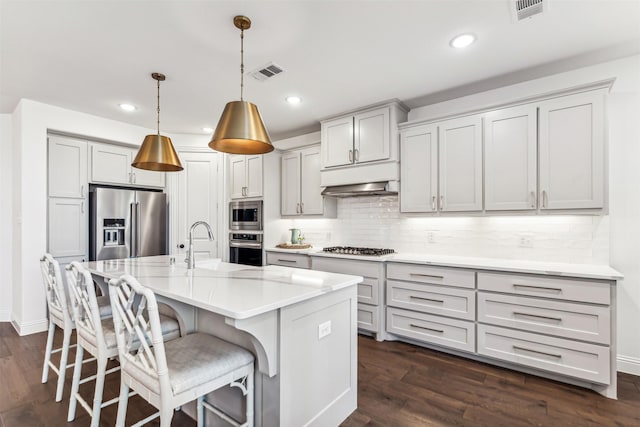 kitchen with visible vents, appliances with stainless steel finishes, and dark wood-style flooring