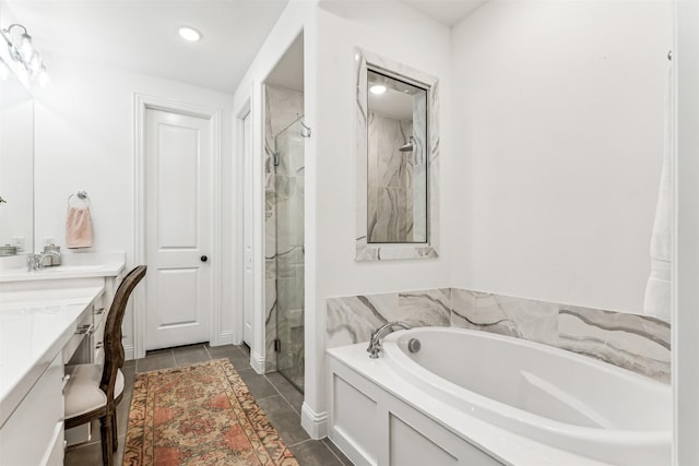 full bath featuring a garden tub, recessed lighting, vanity, a shower stall, and tile patterned floors