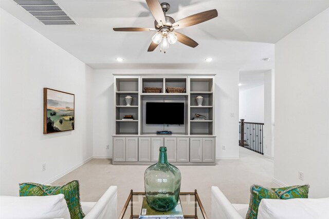 carpeted living room featuring ceiling fan