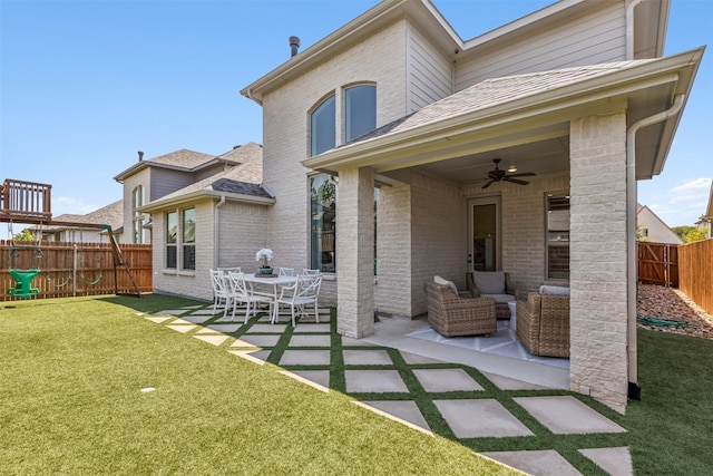 rear view of property featuring brick siding, a patio, a fenced backyard, and ceiling fan