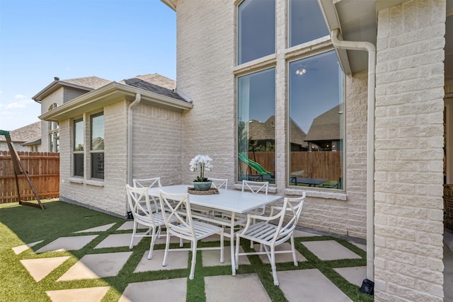 view of patio / terrace with outdoor dining space and fence