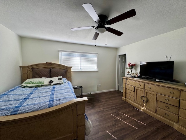 bedroom featuring a textured ceiling, dark hardwood / wood-style floors, and ceiling fan