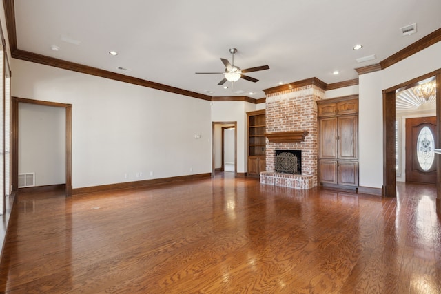 unfurnished living room with ceiling fan, a brick fireplace, crown molding, and dark hardwood / wood-style floors