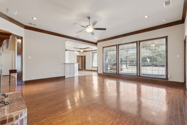 unfurnished living room featuring ceiling fan, ornamental molding, and hardwood / wood-style flooring