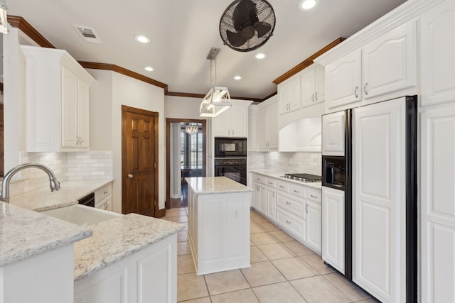 kitchen featuring black appliances, white cabinetry, and tasteful backsplash