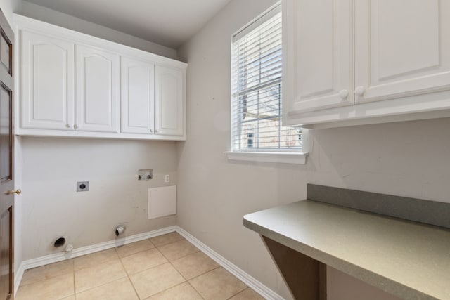 clothes washing area featuring cabinets, washer hookup, hookup for an electric dryer, light tile patterned flooring, and gas dryer hookup