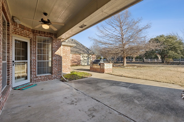 view of patio with exterior kitchen and ceiling fan