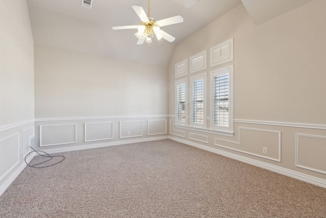 empty room featuring carpet floors, ceiling fan, and vaulted ceiling