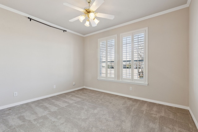 carpeted empty room featuring ceiling fan and ornamental molding