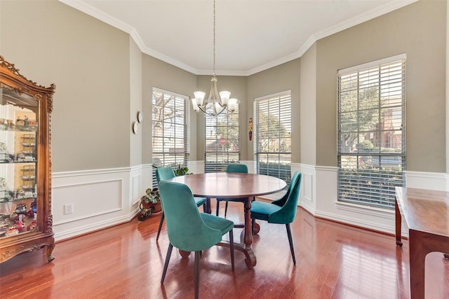 dining room featuring a notable chandelier, a wealth of natural light, and ornamental molding