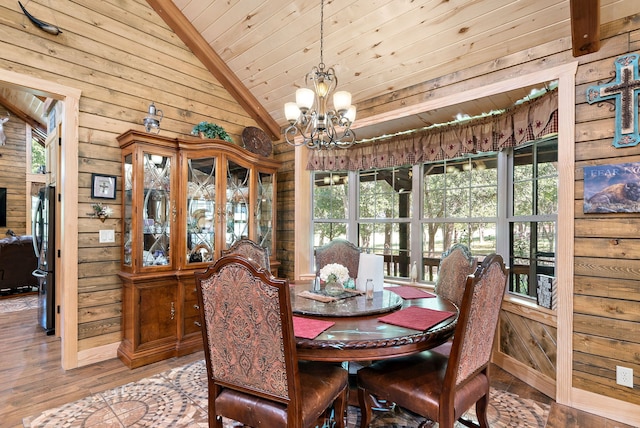 dining area with a notable chandelier, wood ceiling, wood-type flooring, and lofted ceiling