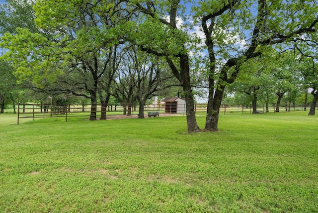 view of yard featuring an outbuilding and a rural view